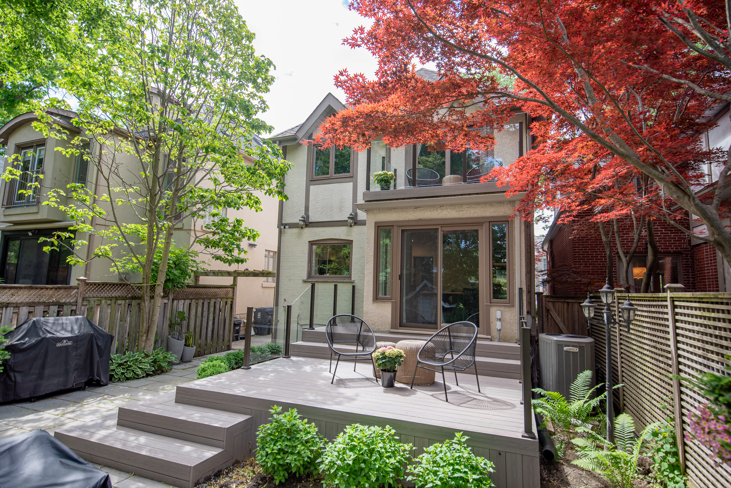 Completed backyard composite deck with black aluminum railings