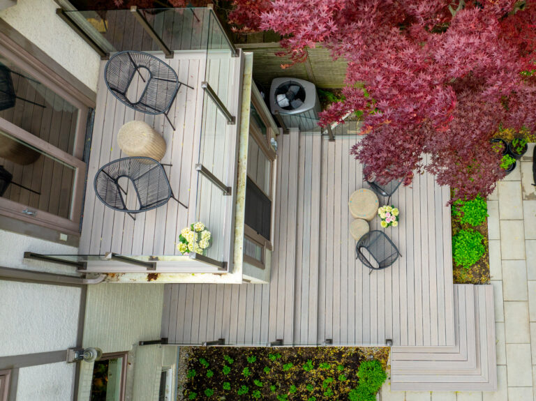 Aerial view of the sleeper-supported rooftop deck above the kitchen and the backyard deck below