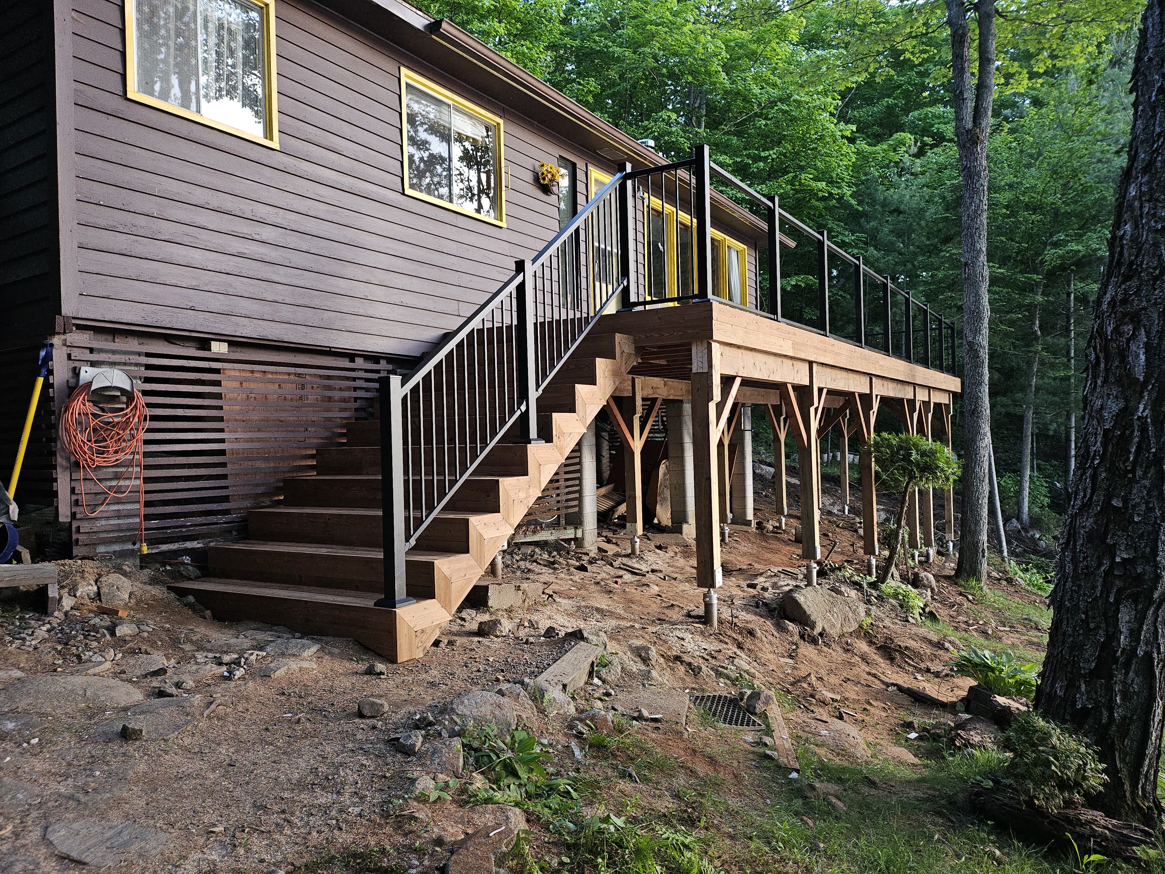 Raised backyard deck structure during construction before the decking boards are installed